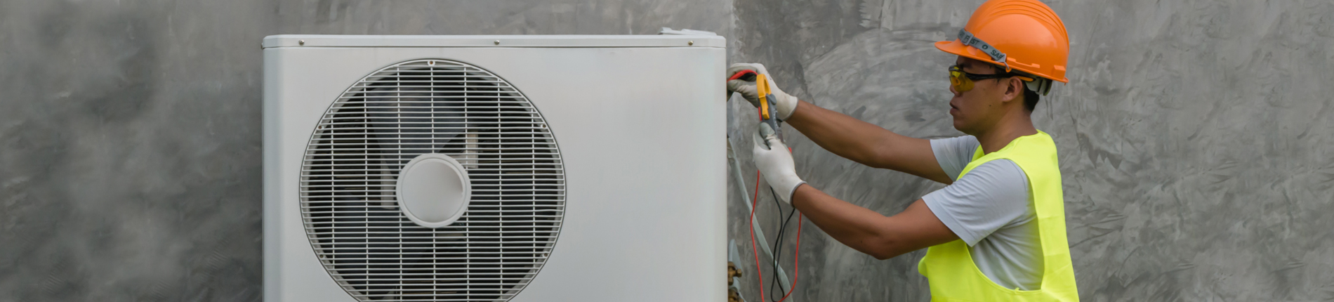 HVAC student working on an air conditioner unit. 