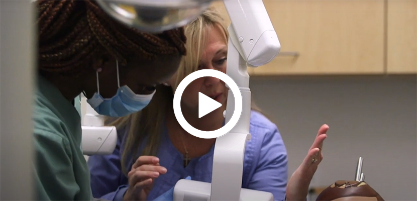 Video play button with Instructor teaching students in the Dental Assistant Training program at Dorsey College