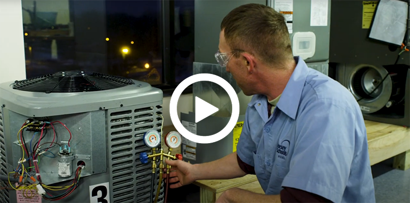 Video play button with an HVAC Training instructor on an A/C unit.